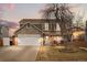 Charming two-story home featuring a stone facade, inviting porch, and a well-manicured front yard at 2924 E 116Th Pl, Thornton, CO 80233