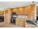 Well-lit kitchen featuring custom wood cabinets, granite countertops, and stainless steel appliances at 2924 E 116Th Pl, Thornton, CO 80233