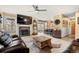 Inviting living room with a stone fireplace, modern ceiling fan, and open floor plan at 2924 E 116Th Pl, Thornton, CO 80233