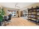 Bright living room showcasing wood floors, a ceiling fan, and an arched entry to the foyer at 2924 E 116Th Pl, Thornton, CO 80233