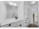 Bright bathroom featuring a modern vanity with marble countertop and a glass-enclosed shower at 34 Benthaven Pl, Boulder, CO 80305