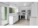 Kitchen features stainless steel appliances, tile backsplash, and access to the back deck at 34 Benthaven Pl, Boulder, CO 80305