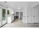 Bright kitchen boasts stainless steel appliances, white cabinets, and a sliding glass door to the deck at 34 Benthaven Pl, Boulder, CO 80305