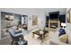 Bright living room featuring a fireplace, hardwood floors, and access to office space at 34 Benthaven Pl, Boulder, CO 80305