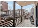Balcony view showcasing stone pavers, gas grill, and views of neighboring townhomes and street at 6946 W Alaska Dr, Lakewood, CO 80226