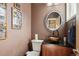 Stylish powder room boasts a unique vessel sink and elegant mirror at 6946 W Alaska Dr, Lakewood, CO 80226