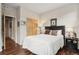 Bedroom with wood floors, white bedding and a closet with sliding doors at 6946 W Alaska Dr, Lakewood, CO 80226