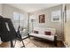 Bedroom featuring exercise equipment, futon, and natural light from the windows at 6946 W Alaska Dr, Lakewood, CO 80226