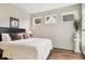 Cozy bedroom with wood floors, large windows, and neutral decor at 6946 W Alaska Dr, Lakewood, CO 80226