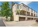 Modern townhome showcases a well-manicured lawn, attached garages, and a balcony at 6946 W Alaska Dr, Lakewood, CO 80226
