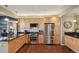 Well-equipped kitchen featuring wooden cabinets, stainless steel appliances, and granite countertops at 6946 W Alaska Dr, Lakewood, CO 80226