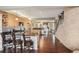 Bright kitchen featuring stainless steel appliances, granite countertops, and an open layout with hardwood floors at 6946 W Alaska Dr, Lakewood, CO 80226