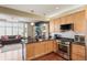 Open kitchen with stainless steel appliances, granite countertops, and a seamless flow into the living area at 6946 W Alaska Dr, Lakewood, CO 80226