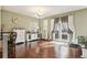 Bright living room with hardwood floors, stylish furnishings, and access to outdoor area for seamless indoor-outdoor living at 6946 W Alaska Dr, Lakewood, CO 80226