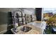 Outdoor kitchen features a sink, grill, and decorative backsplash at 6946 W Alaska Dr, Lakewood, CO 80226