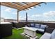 Relax and enjoy the rooftop deck's plush outdoor furniture, shade and lovely neighborhood views at 6946 W Alaska Dr, Lakewood, CO 80226