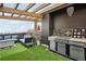This stunning rooftop deck features an outdoor kitchen, comfortable seating, and stylish chandelier at 6946 W Alaska Dr, Lakewood, CO 80226