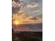 Stunning skyline view featuring a colorful sunset and clouds over the city at 6946 W Alaska Dr, Lakewood, CO 80226