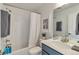Modern bathroom features a shower-tub combination and a gray vanity at 15295 W 68Th Pl, Arvada, CO 80007