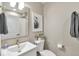 Well-lit bathroom with a decorative bear picture, white vanity, modern faucet, and neutral-toned walls at 15295 W 68Th Pl, Arvada, CO 80007
