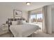 Bright bedroom features a large window and a stylish, patterned headboard at 15295 W 68Th Pl, Arvada, CO 80007