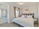 Bright bedroom features a large window and a stylish, patterned headboard at 15295 W 68Th Pl, Arvada, CO 80007