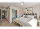 Bright bedroom features a walk-in closet and a stylish, patterned headboard at 15295 W 68Th Pl, Arvada, CO 80007