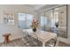 Bright dining room with a large mirror, modern table, and stylish chairs at 15295 W 68Th Pl, Arvada, CO 80007
