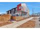 Modern townhome with a unique exterior, privacy fence and side walk on a sunny day at 15295 W 68Th Pl, Arvada, CO 80007