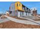 Modern townhome featuring a unique design with multi-tone exterior, neat front yard, and inviting entrance at 15295 W 68Th Pl, Arvada, CO 80007