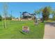 Modern two-story building with a stylish design, outdoor seating area and sign for a fun run at 15295 W 68Th Pl, Arvada, CO 80007
