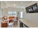 Bright living room featuring a comfortable leather couch, large window, and modern finishes at 15295 W 68Th Pl, Arvada, CO 80007