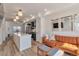 Bright, open living space featuring a modern kitchen island and comfortable leather sofa at 15295 W 68Th Pl, Arvada, CO 80007