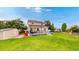 Expansive backyard with a deck, storage shed, manicured lawn, and mature trees, perfect for outdoor enjoyment at 7270 Marmot Ridge Pl, Littleton, CO 80125