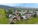 Stunning aerial view of a residential neighborhood nestled among lush greenery with mountain views at 7270 Marmot Ridge Pl, Littleton, CO 80125