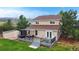 Spacious backyard featuring a deck, storage shed, and mature trees, providing an ideal outdoor living space at 7270 Marmot Ridge Pl, Littleton, CO 80125