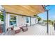 Spacious back deck with awning, seating, and grill, perfect for outdoor entertaining and enjoying the scenery at 7270 Marmot Ridge Pl, Littleton, CO 80125