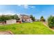 Spacious backyard featuring a deck, storage shed, and well-maintained lawn, creating a private and serene outdoor space at 7270 Marmot Ridge Pl, Littleton, CO 80125