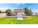 Spacious backyard with a large deck, outdoor seating, a grill, and a well-maintained lawn perfect for outdoor gatherings at 7270 Marmot Ridge Pl, Littleton, CO 80125