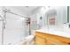 Bathroom featuring a clear glass shower, light wood cabinets, and bright lighting at 7270 Marmot Ridge Pl, Littleton, CO 80125