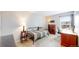 Bedroom with a desk, bed with striped cover, and a display cabinet with glass doors at 7270 Marmot Ridge Pl, Littleton, CO 80125