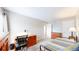 Bedroom with a desk, bed with striped cover, and a dresser with drawers at 7270 Marmot Ridge Pl, Littleton, CO 80125