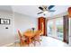Cozy dining area with wood table, ceiling fan and access to an outdoor patio at 7270 Marmot Ridge Pl, Littleton, CO 80125