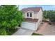 Two-story home with tan siding, new brown shingle roof and well-maintained landscaping at 7270 Marmot Ridge Pl, Littleton, CO 80125
