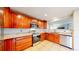 Well-lit kitchen with stainless steel appliances, granite countertops, and tile flooring at 7270 Marmot Ridge Pl, Littleton, CO 80125