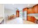 Bright kitchen and dining area featuring tile floors, stainless steel refrigerator, and cabinets at 7270 Marmot Ridge Pl, Littleton, CO 80125