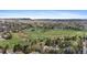 An aerial view showcasing the neighborhood, golf course, and surrounding landscape at 8132 Lodgepole Trl, Lone Tree, CO 80124