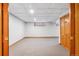 Unfinished basement area with carpet and a tile ceiling at 8132 Lodgepole Trl, Lone Tree, CO 80124