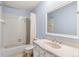 Simple bathroom with a tub and shower combination, a vanity sink, and a mirror at 8132 Lodgepole Trl, Lone Tree, CO 80124