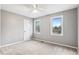 Light-filled bedroom with carpet, two windows, and white trim at 8132 Lodgepole Trl, Lone Tree, CO 80124